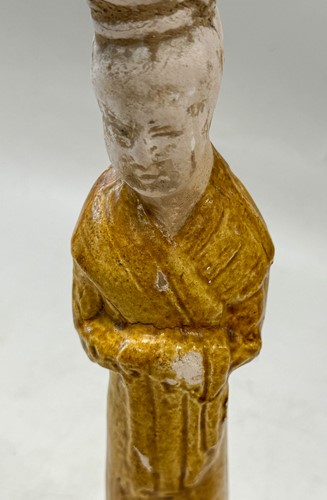 Lot 7 - A group of four Chinese partly straw-glazed pottery lady court attendants, Tang Dynasty
