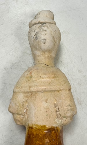 Lot 7 - A group of four Chinese partly straw-glazed pottery lady court attendants, Tang Dynasty