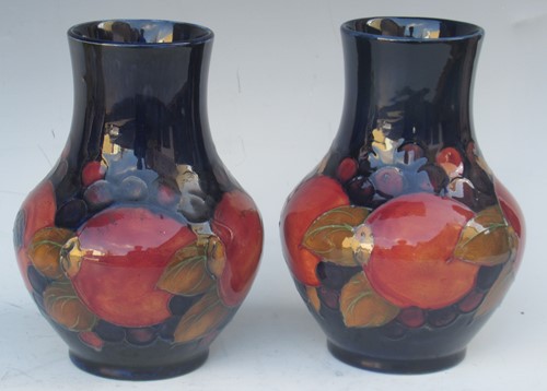 Lot 29 - A pair of Moorcroft Pomegranate pattern vases...