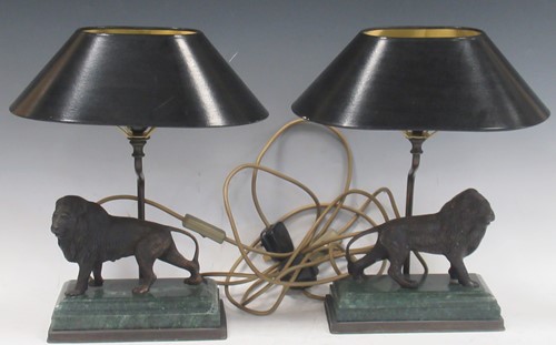 Lot 35 - A pair of bronze table lamps modelled as lions...