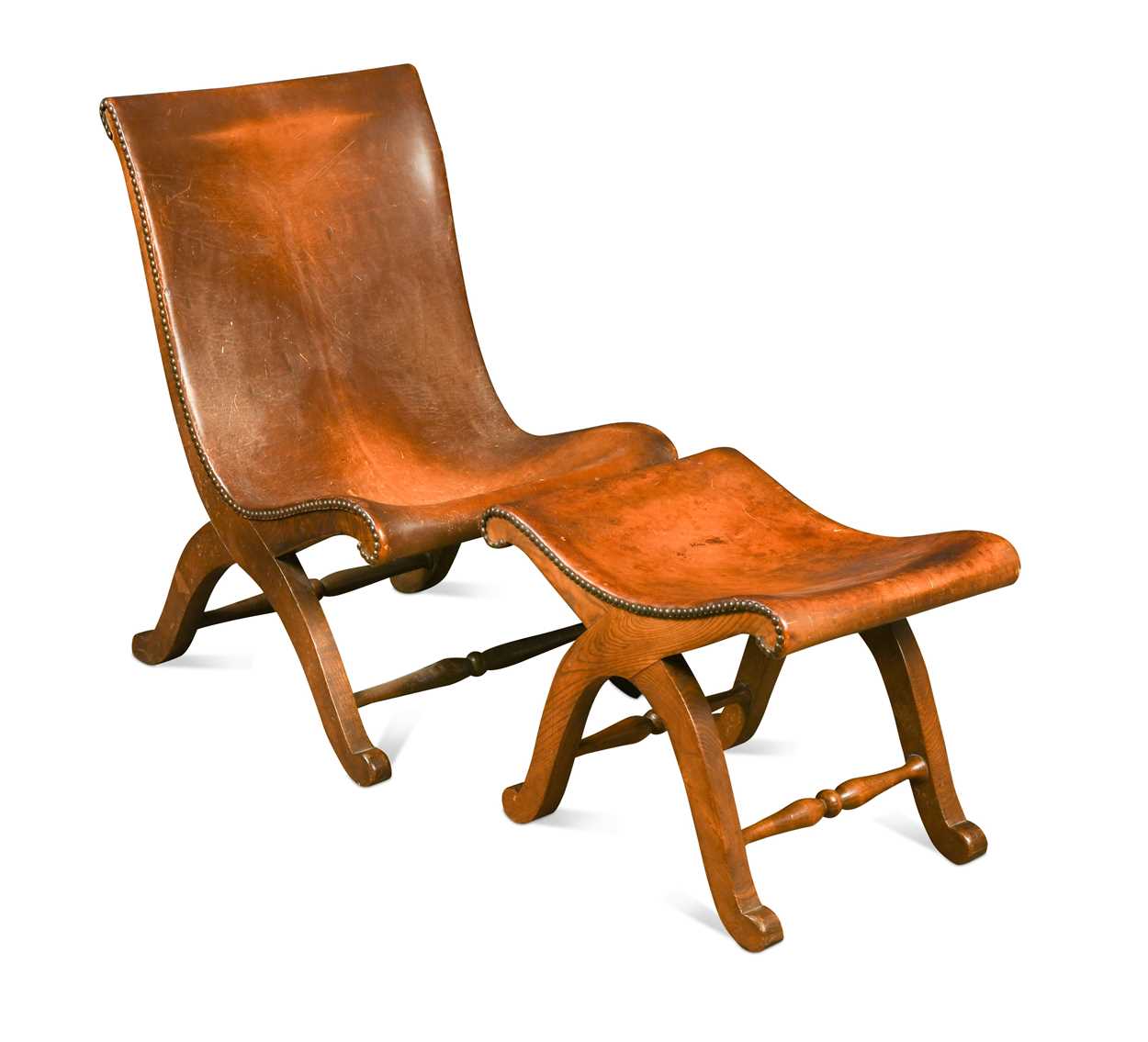 Lot 590 - A Spanish style leather covered chair and foot stool, late 20th century