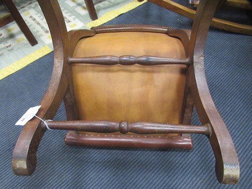 Lot 590 - A Spanish style leather covered chair and foot stool, late 20th century