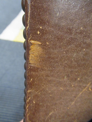 Lot 590 - A Spanish style leather covered chair and foot stool, late 20th century