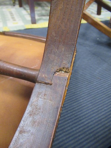 Lot 590 - A Spanish style leather covered chair and foot stool, late 20th century