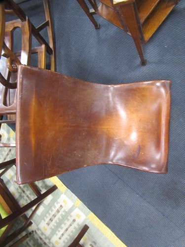 Lot 590 - A Spanish style leather covered chair and foot stool, late 20th century
