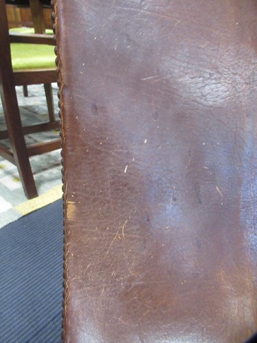 Lot 590 - A Spanish style leather covered chair and foot stool, late 20th century