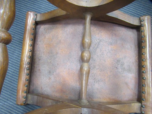 Lot 590 - A Spanish style leather covered chair and foot stool, late 20th century