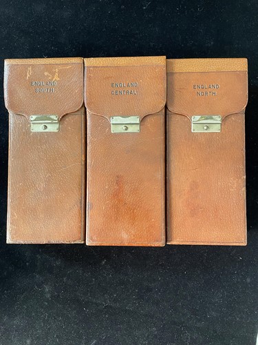 Lot 59 - Three folding sets of travel maps in leather cases, early 20th century