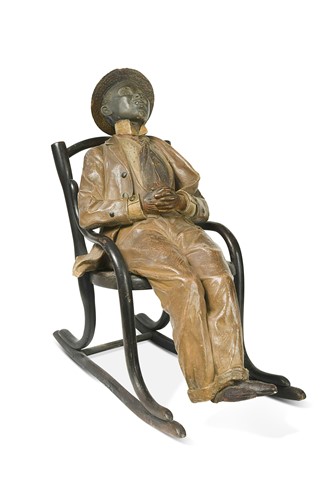 Lot 28 - A Goldscheider model of a seated male figure on a rocking chair