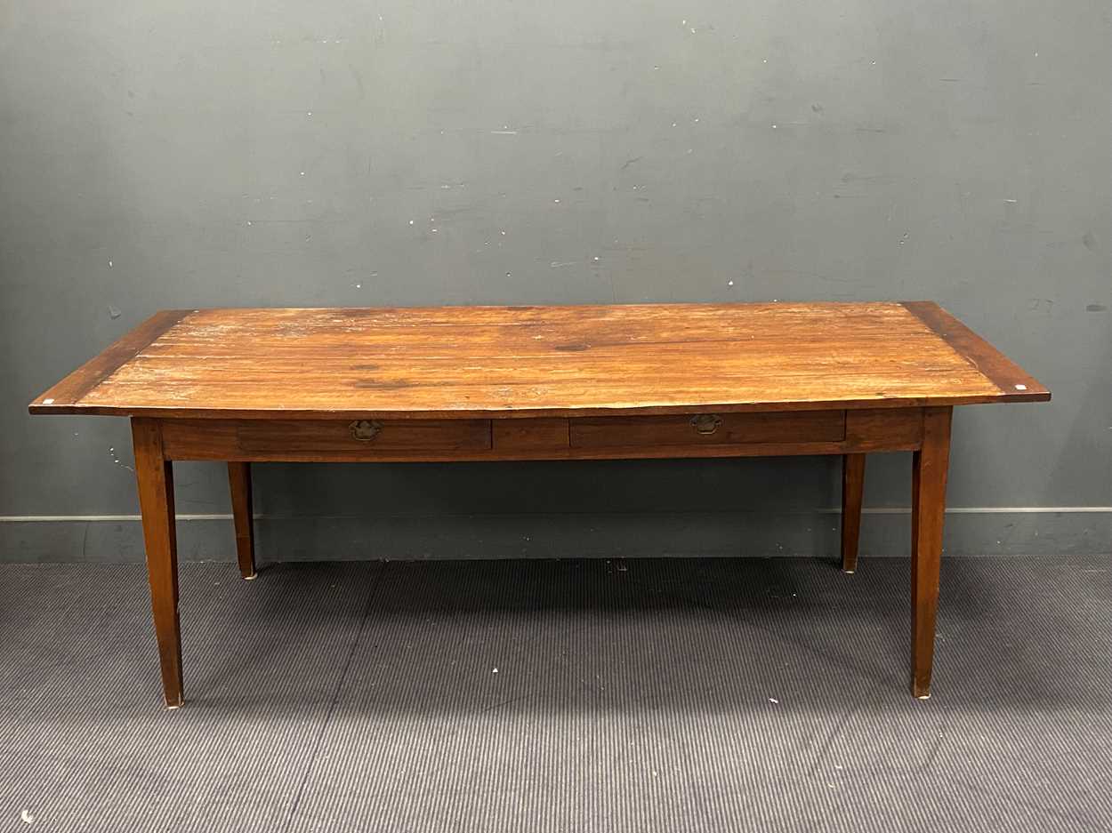 Lot 399 - A French fruitwood dining table with plank top...