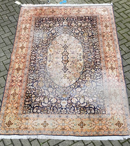 Lot 509 - A worn Oriental carpet