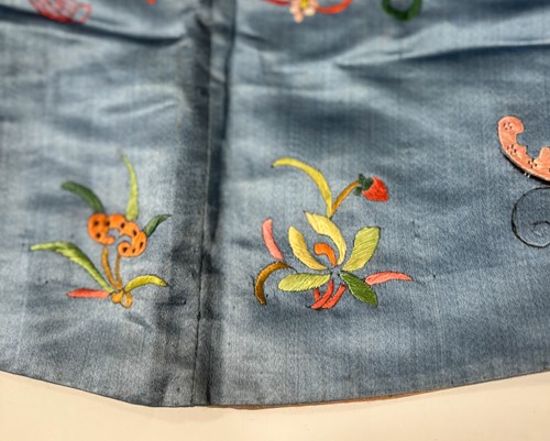 Lot 20 - A Chinese child's blue silk embroidered jacket, early 20th century
