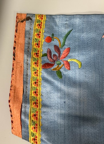 Lot 20 - A Chinese child's blue silk embroidered jacket, early 20th century