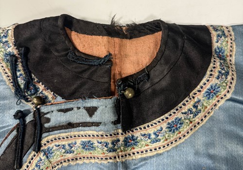 Lot 20 - A Chinese child's blue silk embroidered jacket, early 20th century