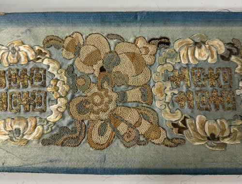 Lot 20 - A Chinese child's blue silk embroidered jacket, early 20th century
