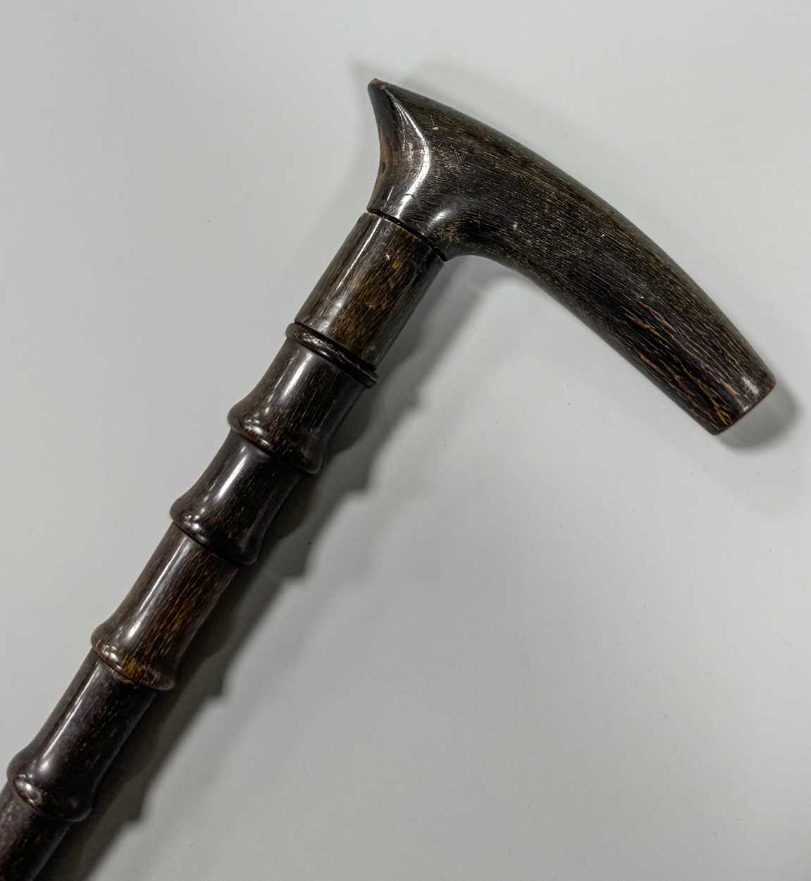 Lot 199 - A sectional walking cane, possibly rhino horn,...