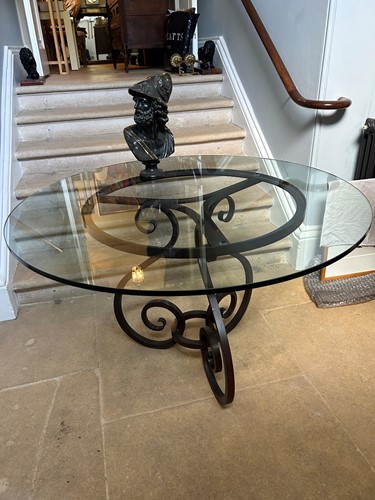 Lot 690 - A glass topped circular table on a bronze...