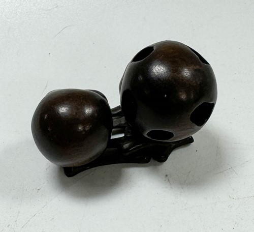 Lot 46 - A Japanese carved hardwood netsuke as two skulls and bones, 20th century
