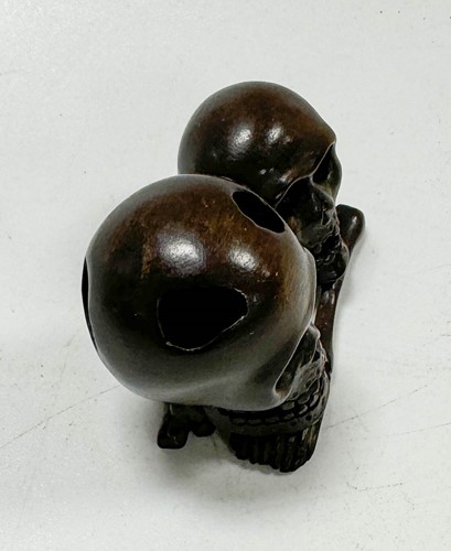 Lot 46 - A Japanese carved hardwood netsuke as two skulls and bones, 20th century