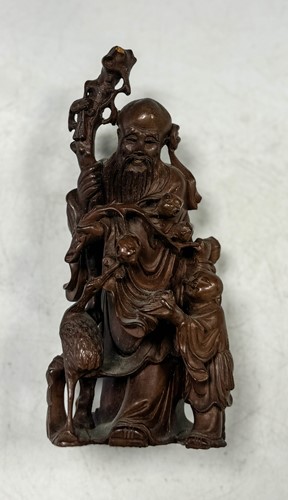 Lot 38 - A Chinese carved wood Shoulao and boy attendant, Qing Dynasty, late 19th century