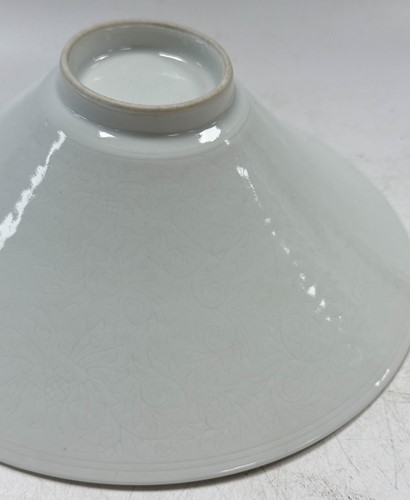 Lot 2 - A pair of Chinese white glazed "hidden decoration" floral bowls, 18th century