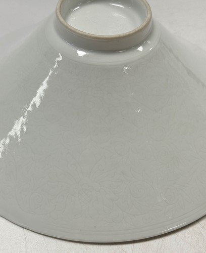 Lot 2 - A pair of Chinese white glazed "hidden decoration" floral bowls, 18th century