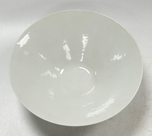 Lot 2 - A pair of Chinese white glazed "hidden decoration" floral bowls, 18th century