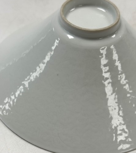 Lot 2 - A pair of Chinese white glazed "hidden decoration" floral bowls, 18th century