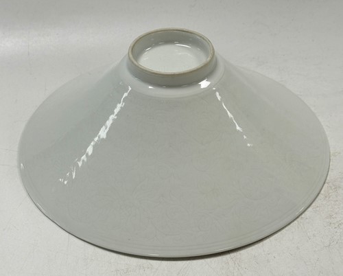 Lot 2 - A pair of Chinese white glazed "hidden decoration" floral bowls, 18th century