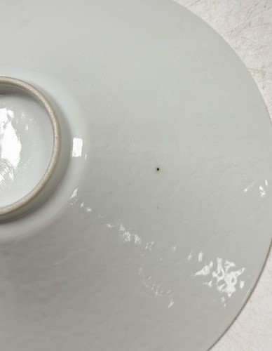Lot 2 - A pair of Chinese white glazed "hidden decoration" floral bowls, 18th century
