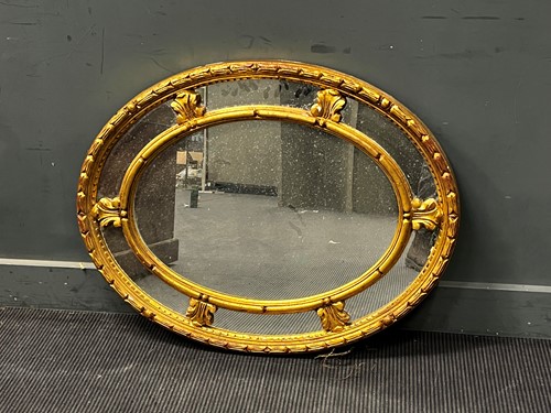 Lot 443 - A George III style gilt framed oval wall...