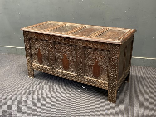 Lot 396 - A 17th century carved oak coffer in the West...