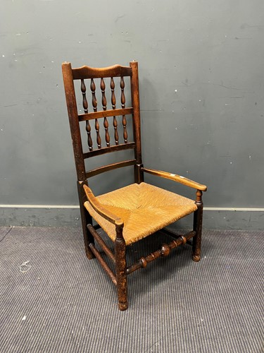 Lot 418 - An oak spindle back child's armchair with rush...