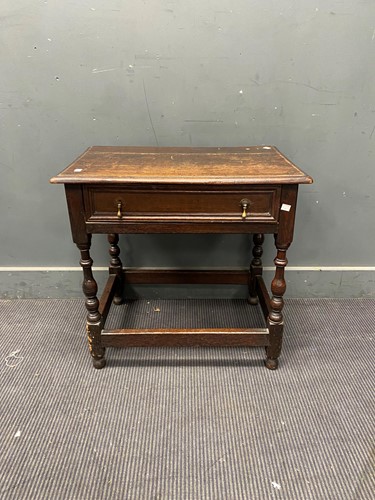 Lot 343 - An 18th century oak side table with cushion...