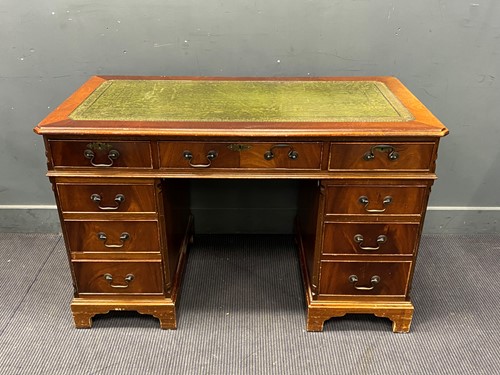Lot 421 - A mahogany pedestal desk with green leather...