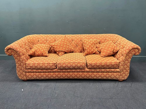 Lot 398 - A large three seater sofa upholstered in red...