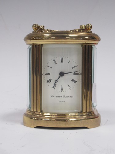 Lot 175 - A modern small oval carriage timepiece by...