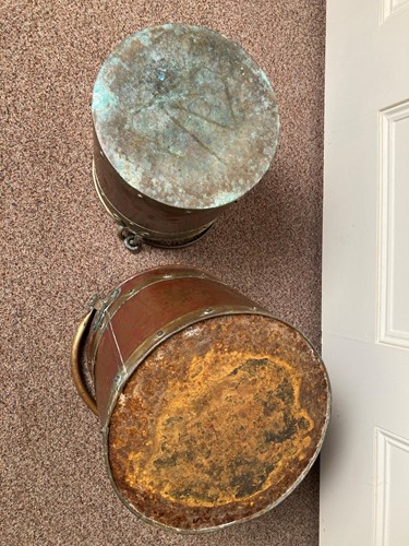 Lot 619 - A near pair of Edwardian brass and copper log baskets