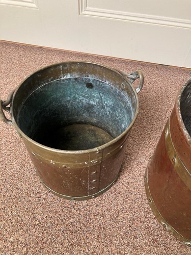 Lot 619 - A near pair of Edwardian brass and copper log baskets