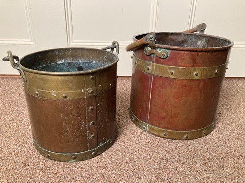 Lot 619 - A near pair of Edwardian brass and copper log baskets