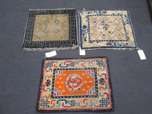 Lot 872 - A Tibetan Gomden pillow rug with orange ground...