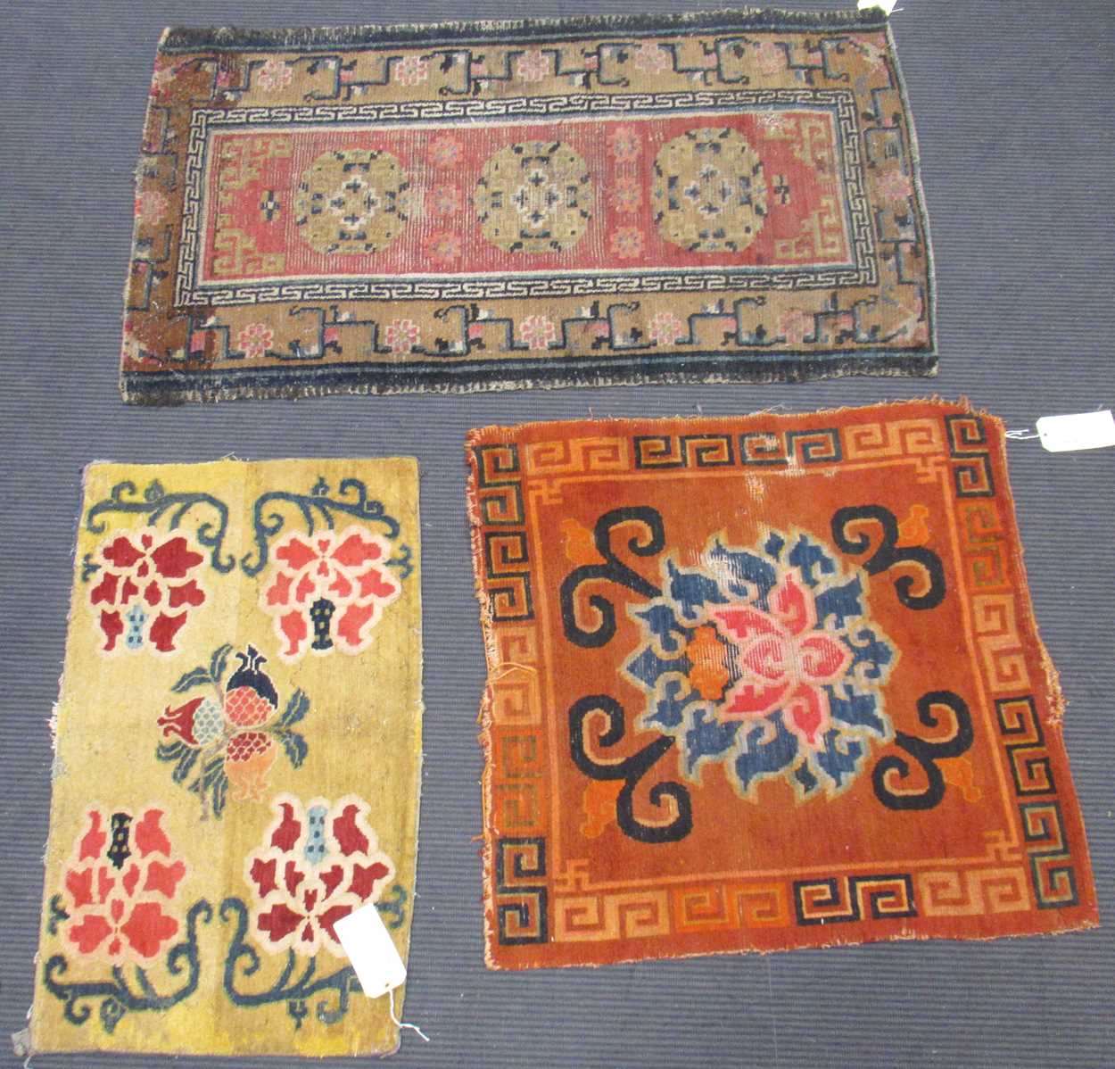 Lot 871 - A Tibetan wool rug, 20th century, the dark...