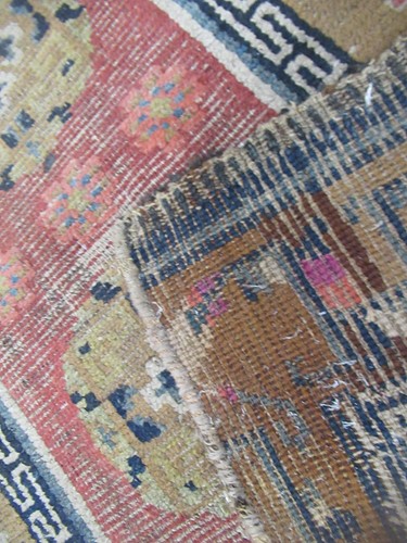 Lot 871 - A Tibetan wool rug, 20th century, the dark...
