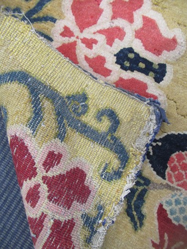 Lot 871 - A Tibetan wool rug, 20th century, the dark...