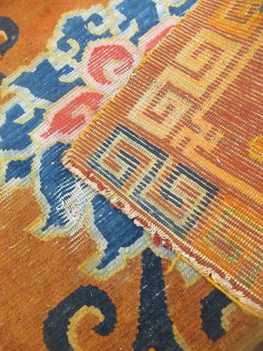 Lot 871 - A Tibetan wool rug, 20th century, the dark...