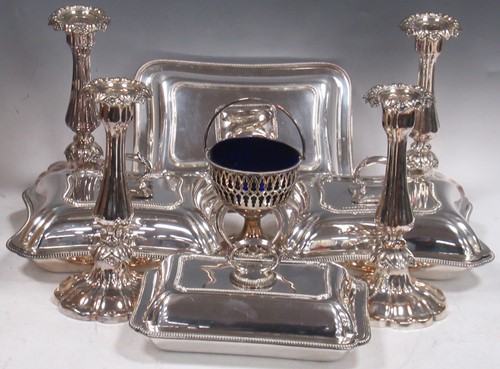 Lot 378 - A set of four silverplated candlesticks,...