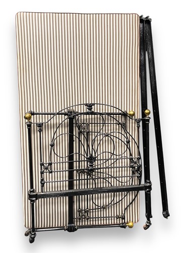 Lot 757 - An early 20th century cast iron bed, black...