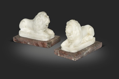 Lot 665 - A pair of marble composition recumbent lions, late 19th / early 20th century