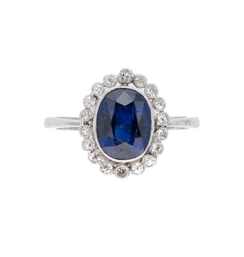 Lot 180 - A sapphire and diamond cluster ring