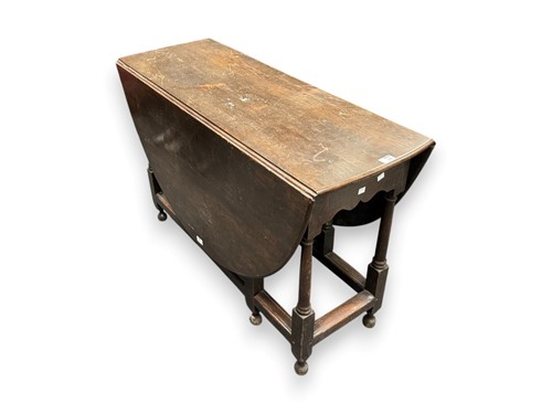 Lot 556 - A stained oak gate leg table, 72 x 112 x 42cm...